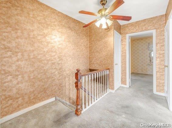 interior space with ceiling fan and carpet floors