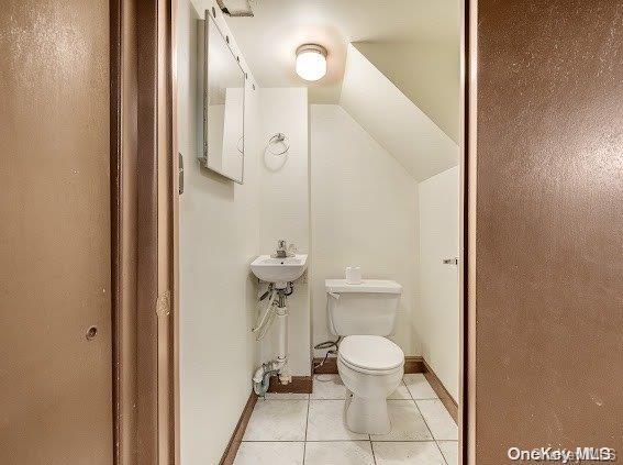 bathroom featuring tile patterned flooring and toilet