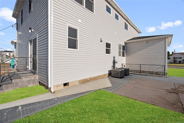 back of house with a lawn and a patio area