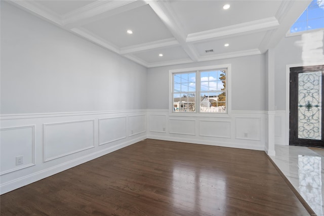 spare room with beam ceiling, dark hardwood / wood-style flooring, ornamental molding, and coffered ceiling