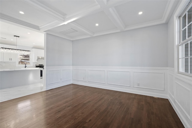 unfurnished room featuring beam ceiling, coffered ceiling, dark hardwood / wood-style floors, and ornamental molding