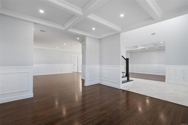 empty room featuring beamed ceiling, ornamental molding, and hardwood / wood-style flooring