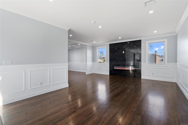 unfurnished living room featuring a fireplace, dark hardwood / wood-style floors, and ornamental molding