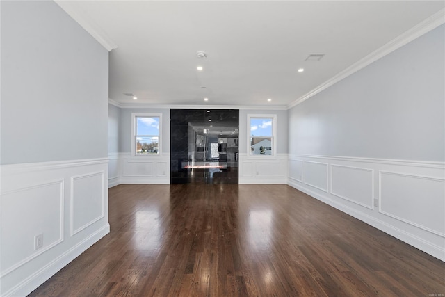 unfurnished living room with crown molding and dark wood-type flooring