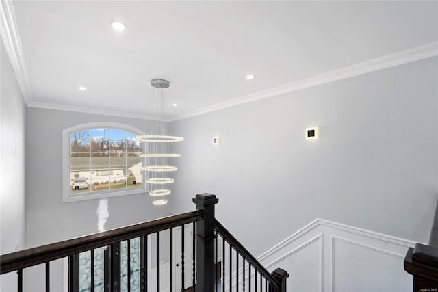 hallway with an inviting chandelier and crown molding