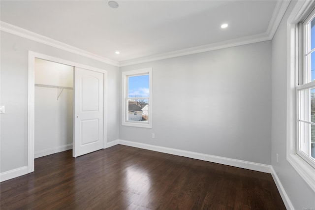 unfurnished bedroom featuring a closet, dark hardwood / wood-style flooring, and ornamental molding