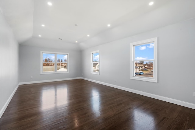 unfurnished room featuring vaulted ceiling and dark wood-type flooring