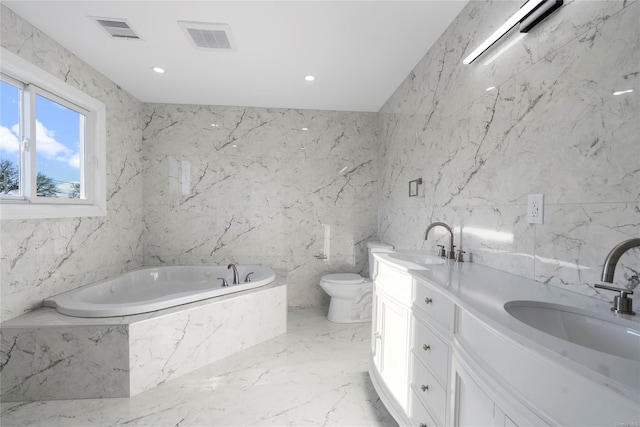 bathroom with vanity, a bathtub, toilet, and tile walls