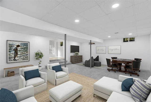 carpeted living room featuring a paneled ceiling