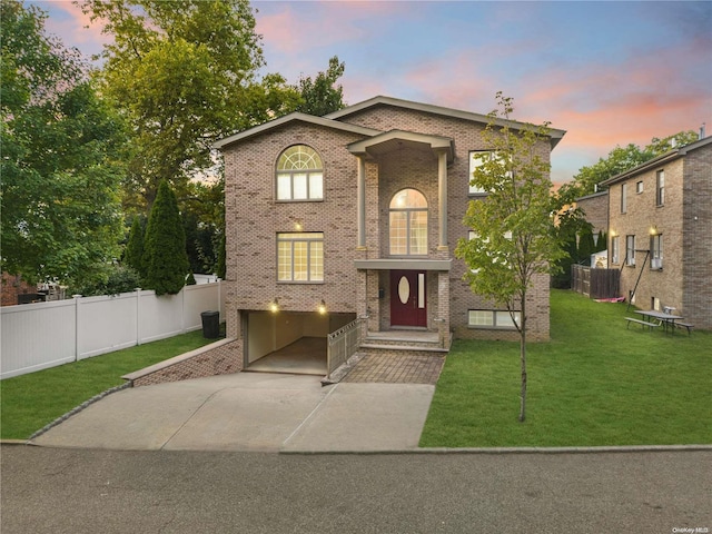 view of front of house with a lawn and a garage