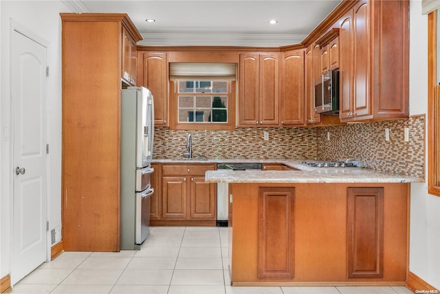 kitchen featuring kitchen peninsula, appliances with stainless steel finishes, tasteful backsplash, crown molding, and sink