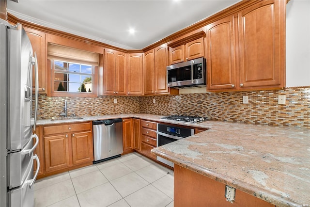 kitchen featuring light stone countertops, sink, decorative backsplash, light tile patterned flooring, and appliances with stainless steel finishes