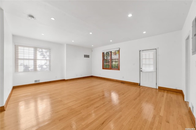 empty room with a healthy amount of sunlight and light wood-type flooring