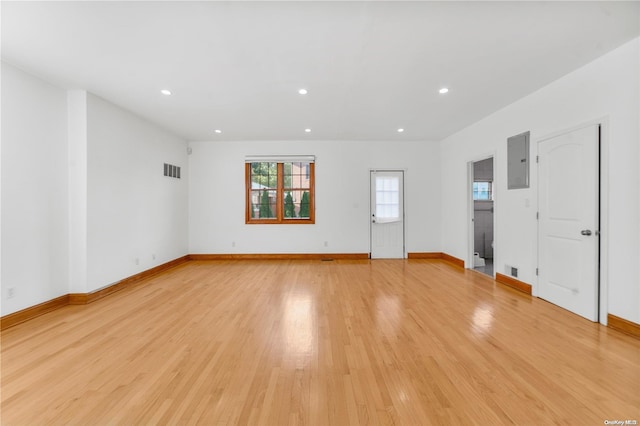 unfurnished living room with light wood-type flooring and electric panel