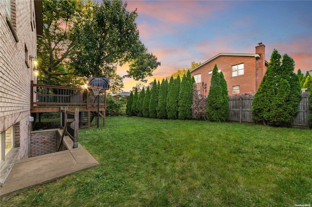 yard at dusk with a deck