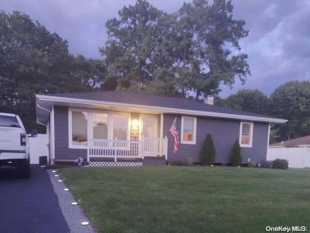 view of front facade with a porch and a yard