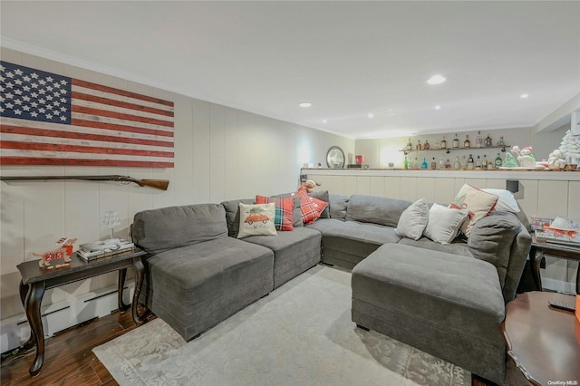 living room featuring hardwood / wood-style flooring, baseboard heating, and crown molding