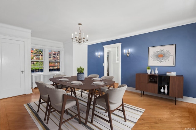 dining room with a chandelier, light hardwood / wood-style floors, and crown molding