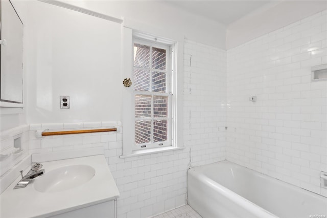 bathroom with a bath, vanity, tile patterned floors, and tile walls