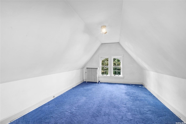 additional living space with carpet flooring, lofted ceiling, and radiator