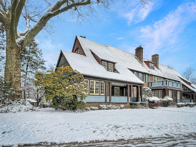 view of snow covered back of property