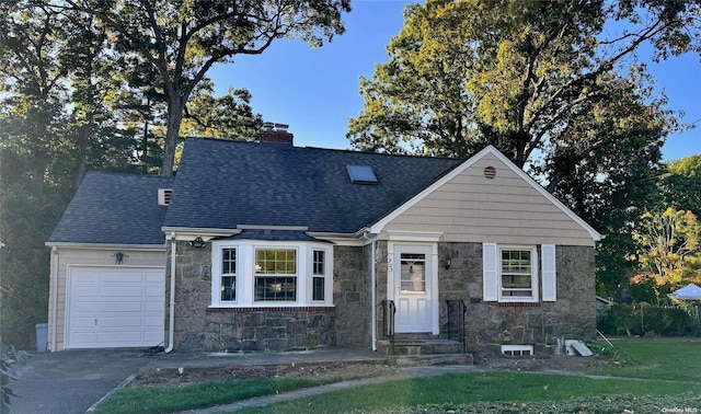 view of front of home featuring a garage and a front lawn