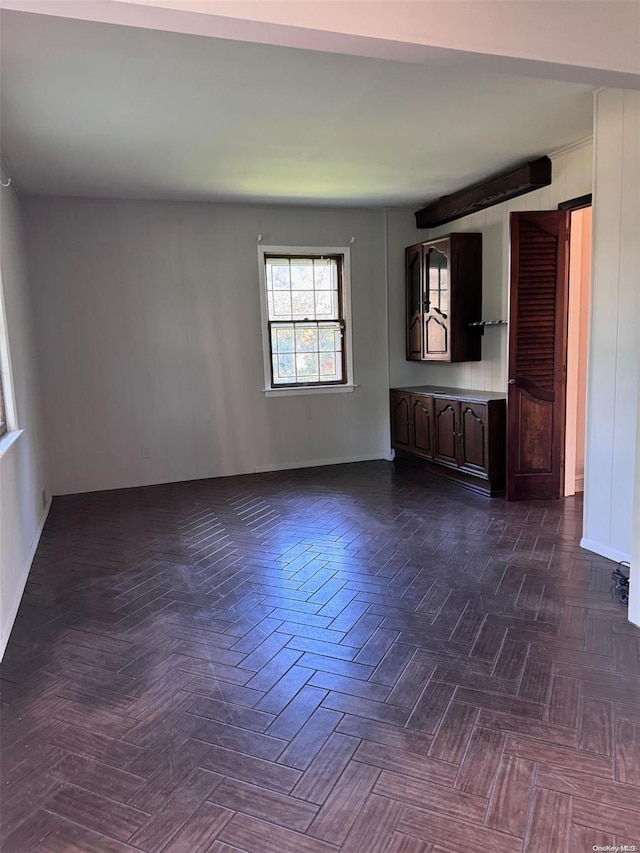 unfurnished living room with dark parquet floors