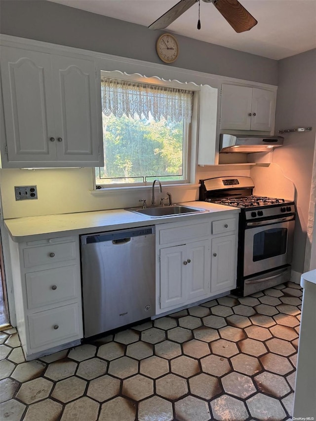 kitchen with sink, ceiling fan, range hood, white cabinetry, and stainless steel appliances