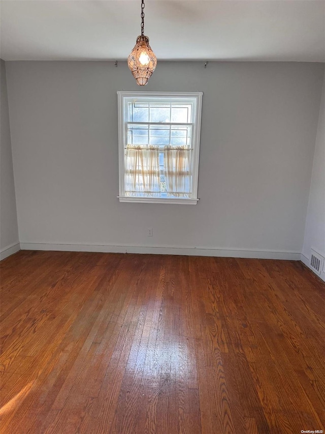 spare room with wood-type flooring