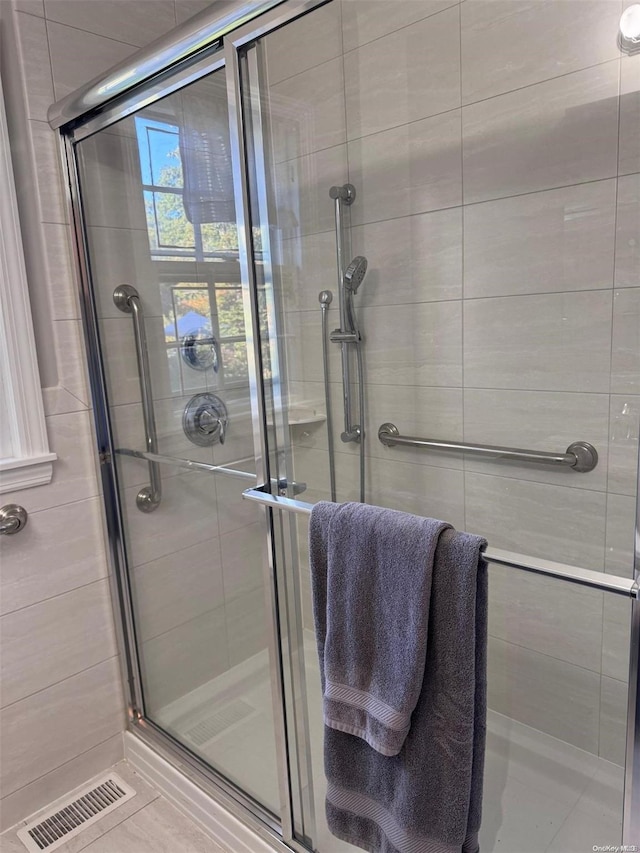 bathroom featuring tile patterned flooring and walk in shower