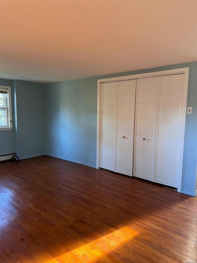 unfurnished bedroom featuring dark wood-type flooring