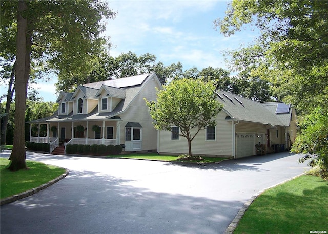 cape cod home with a porch and a garage