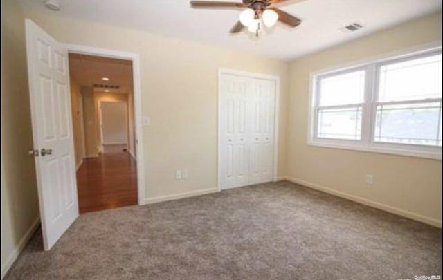 unfurnished bedroom with carpet floors, ceiling fan, and a closet