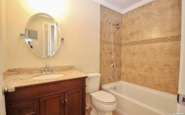 full bathroom with toilet, tiled shower / bath combo, vanity, and ornamental molding