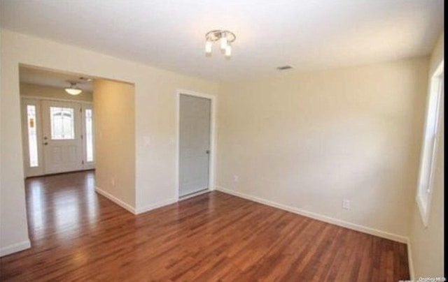 spare room featuring dark wood-type flooring