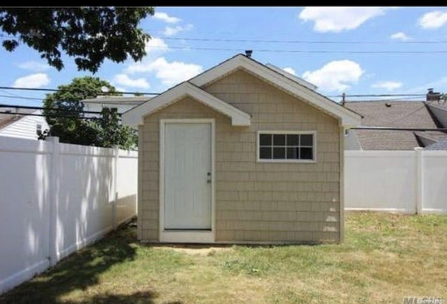 view of outbuilding featuring a lawn