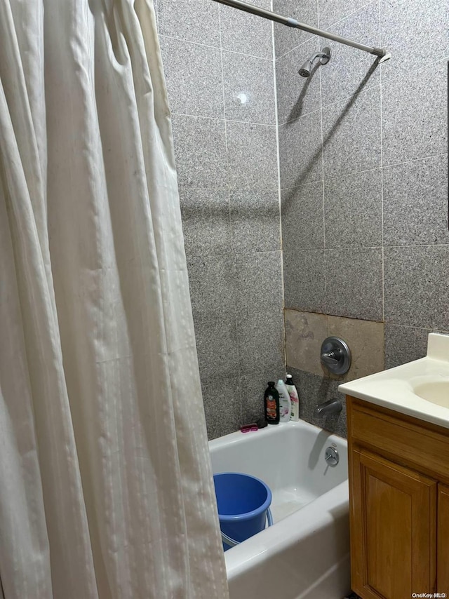 bathroom with shower / bath combo and tile walls