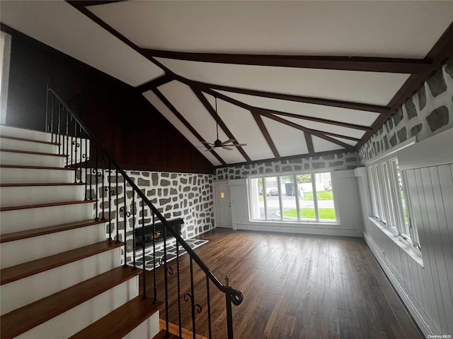 unfurnished living room featuring vaulted ceiling with beams, ceiling fan, and hardwood / wood-style flooring