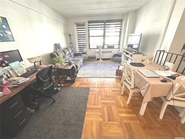 office space with radiator and light parquet flooring