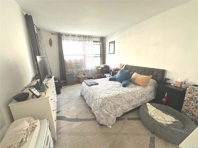 bedroom featuring light colored carpet