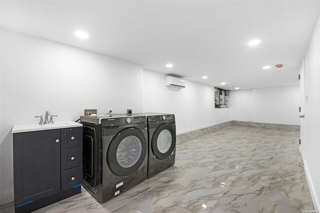 laundry room featuring separate washer and dryer, sink, and a wall unit AC