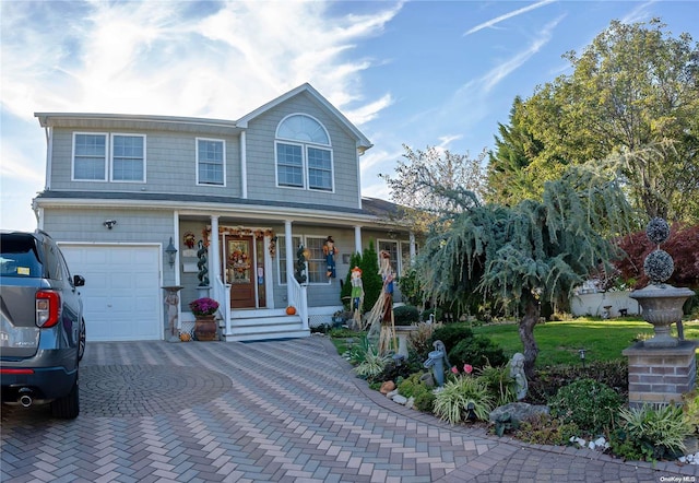 view of front of house featuring a front lawn, a porch, and a garage