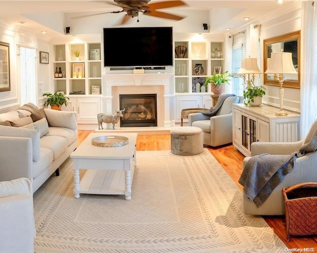 living room with ceiling fan and light hardwood / wood-style floors