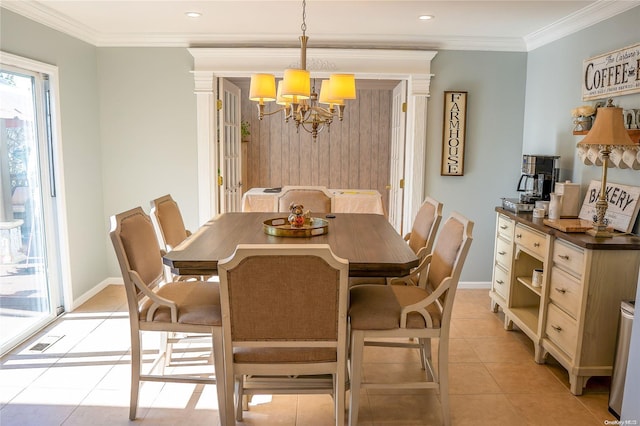 dining area with ornamental molding, light tile patterned floors, and a chandelier