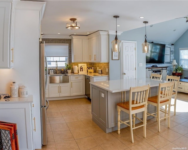 kitchen with white cabinetry, plenty of natural light, a breakfast bar area, and light tile patterned flooring