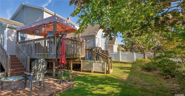 view of playground with a lawn, a gazebo, and a deck