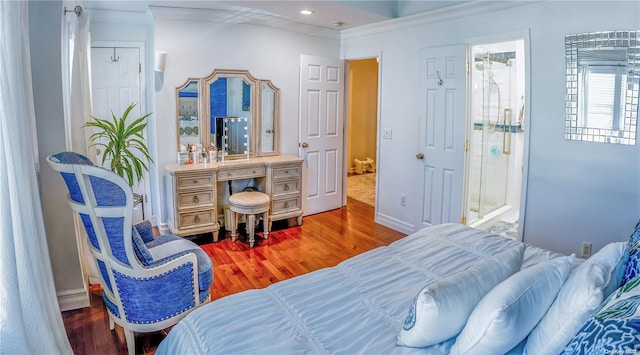 bedroom with ensuite bathroom, wood-type flooring, and ornamental molding