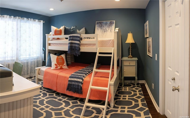 bedroom with dark wood-type flooring