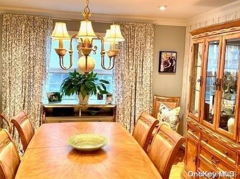 dining room with a chandelier and crown molding