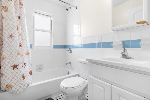 full bathroom with shower / bath combo, tile patterned floors, toilet, vanity, and tile walls